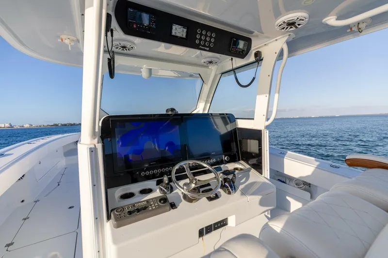 Slide: The Image of 2024 Freeman 47 boat cockpit with advanced navigation system and ocean view. - 4