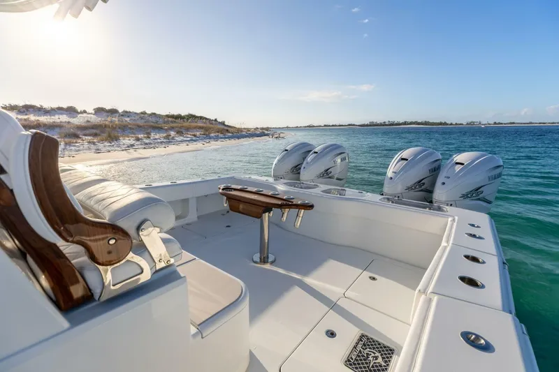 Slide: The Image of 2024 Freeman 47 boat with Yamaha engines near a sandy beach. - 7