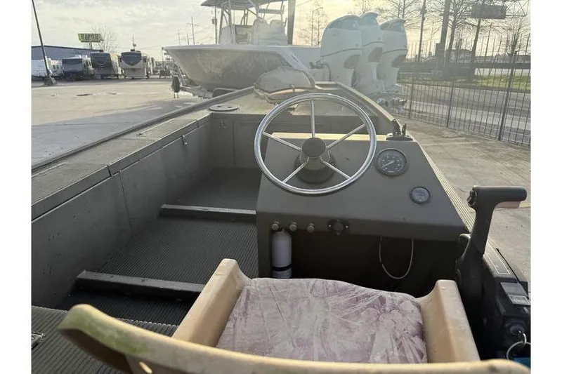 Slide: The Image of 2012 Gator Trax 17X54 boat interior with steering wheel and seating. - 7