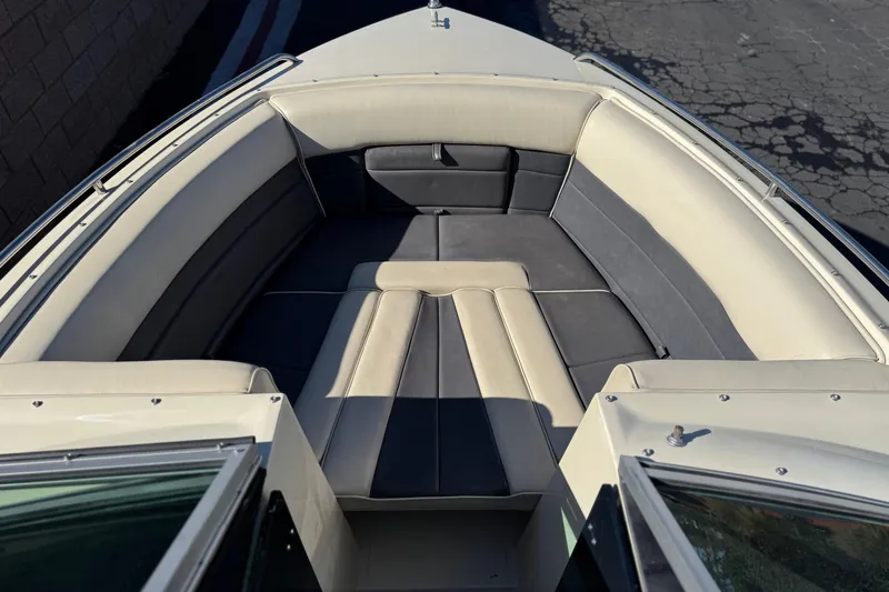 Slide: The Image of Interior of 1988 Cobalt 222 boat with cushioned seating in neutral tones. - 10