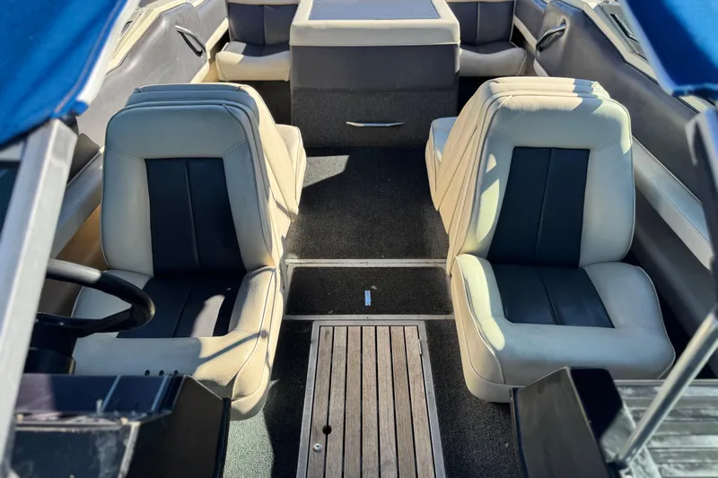 Slide: The Image of Interior of a 1988 Cobalt 222 boat with beige and black seating. - 13