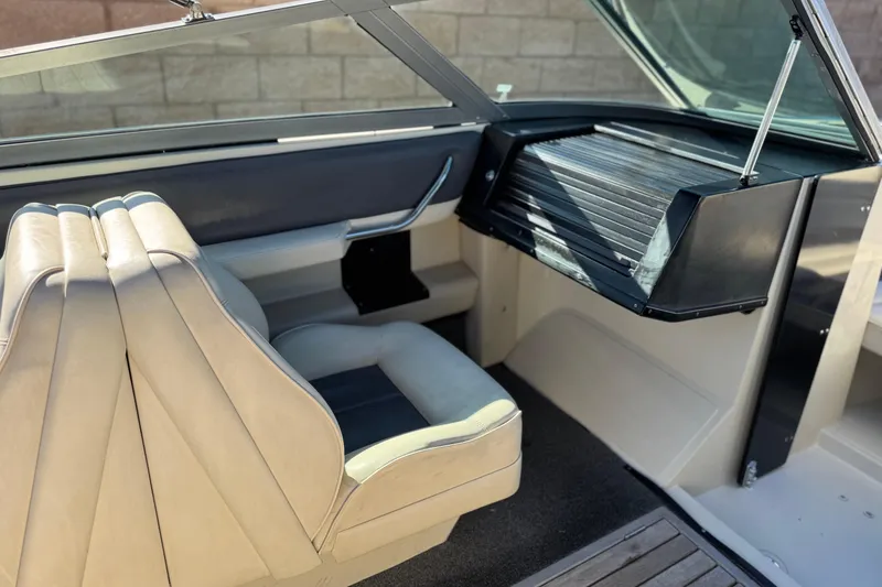 Slide: The Image of Interior of a 1988 Cobalt 222 boat with beige seating and dashboard. - 18