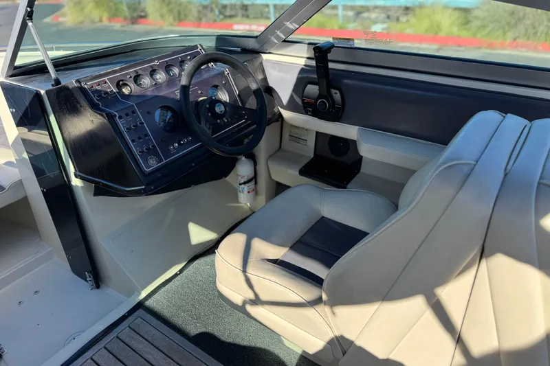 Slide: The Image of 1988 Cobalt 222 boat interior with steering wheel and dashboard controls. - 21