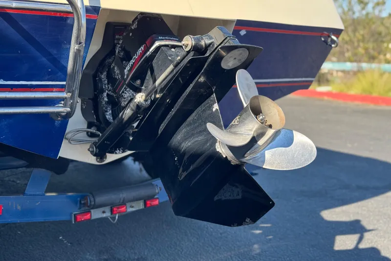 Slide: The Image of 1988 Cobalt 222 boat with Mercury outboard motor and propeller, parked on a trailer. - 7