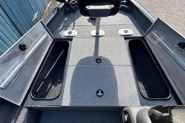 Slide: The Image of 2019 Tracker Pro Team 175 TF boat interior with open storage compartments and seating. - 11