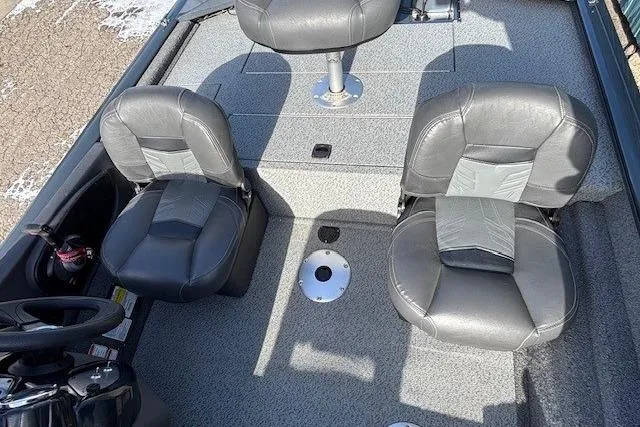 Slide: The Image of 2019 Tracker Pro Team 175 TF boat interior with gray seating and steering wheel. - 15