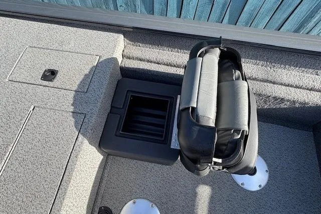 Slide: The Image of 2019 Tracker Pro Team 175 TF boat interior with folded seat and storage compartment. - 17