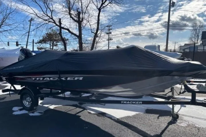 Slide: The Image of 2019 Tracker Pro Team 175 TF boat covered, parked on trailer in snowy outdoor setting. - 25