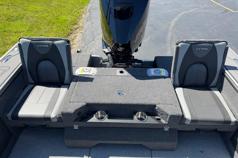 Slide: The Image of 2026 Lund 1875 Pro-V boat interior with seating and motor, showcasing modern design. - 10