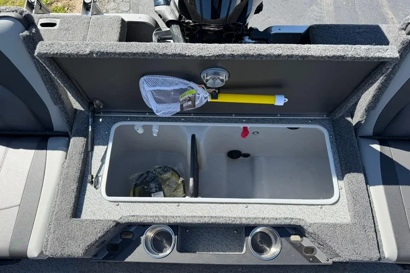 Slide: The Image of 2026 Lund 1875 Pro-V boat interior with storage compartment and fishing net. - 11