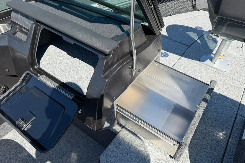 Slide: The Image of 2026 Lund 1875 Pro-V boat interior with open storage compartment and seating. - 17