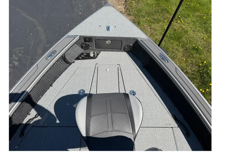 Slide: The Image of 2026 Lund 1875 Pro-V boat interior with seating and storage compartments. - 18
