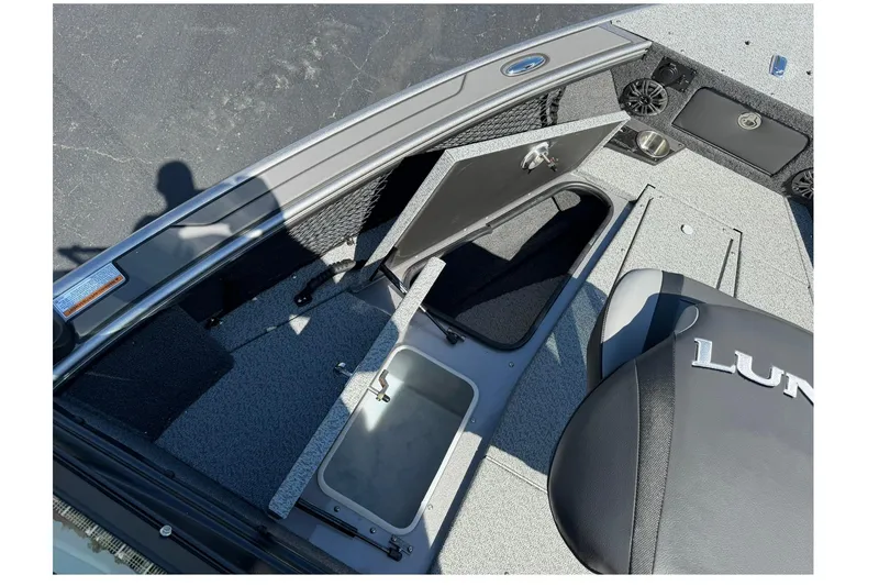 Slide: The Image of 2026 Lund 1875 Pro-V boat interior with open storage compartments and seating. - 22