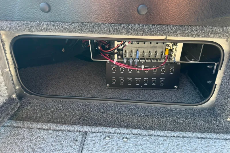 Slide: The Image of Electrical panel inside 2026 Lund 1875 Pro-V boat, showcasing wiring and fuse setup. - 24