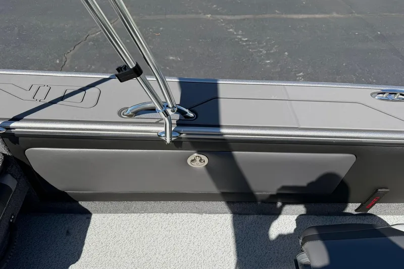 Slide: The Image of 2026 Lund 1875 Pro-V boat interior with rod holder and storage compartment. - 25