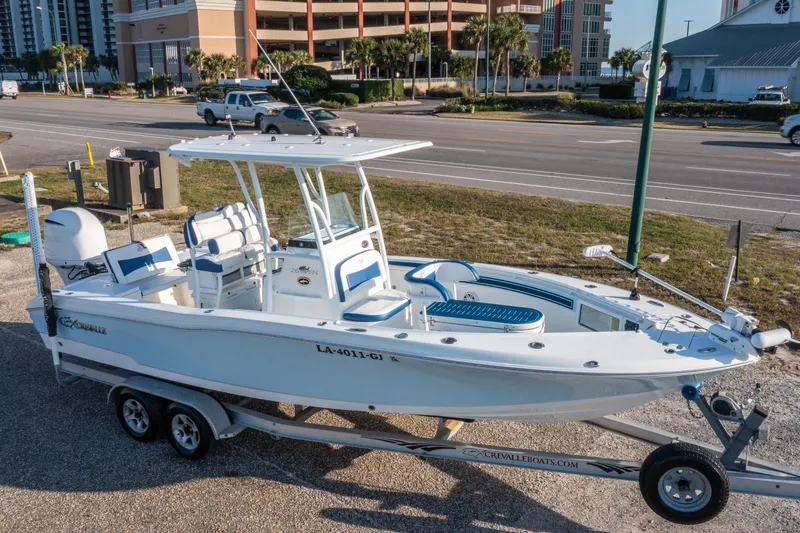 The Image of 2017 Crevalle 26 Open boat on trailer, parked near a road. - 0