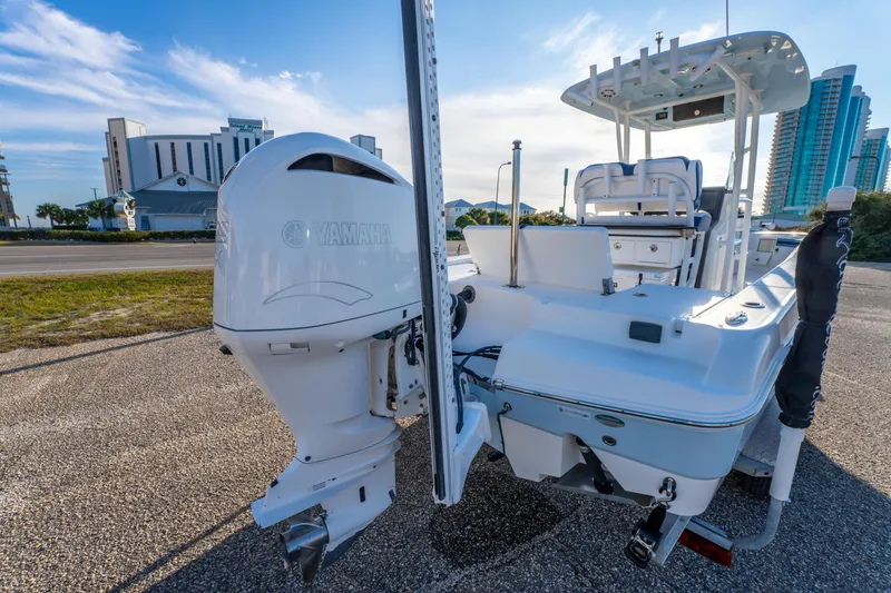 Slide: The Image of 2017 Crevalle 26 Open boat with Yamaha outboard motor, parked on a sunny day. - 11