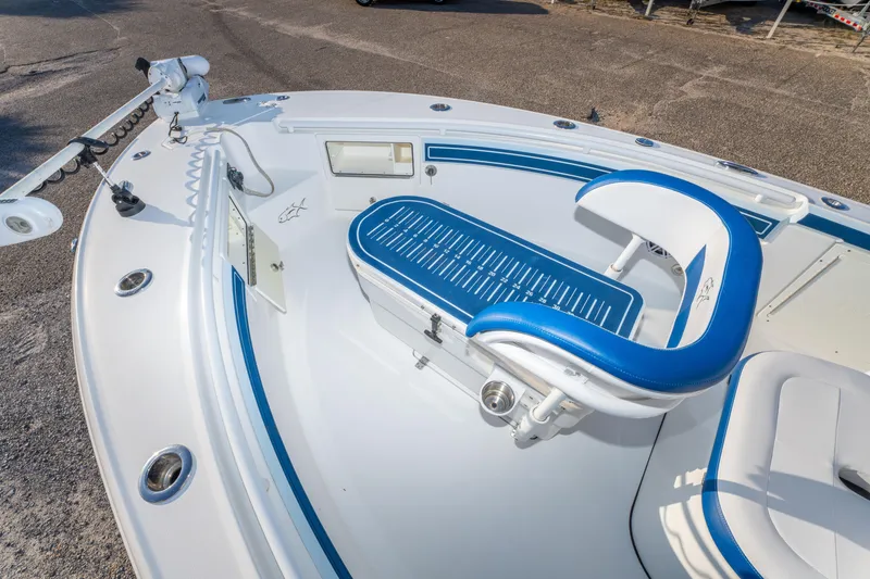 Slide: The Image of 2017 Crevalle 26 Open boat interior with blue and white seating and fishing equipment. - 14