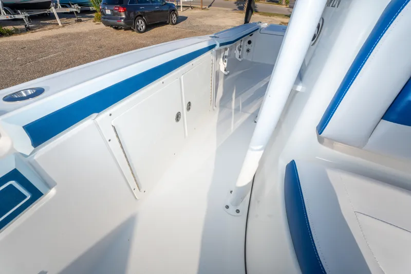 Slide: The Image of 2017 Crevalle 26 Open boat interior with blue and white seating. - 22