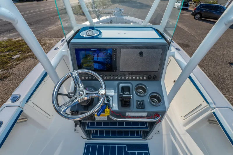 Slide: The Image of 2017 Crevalle 26 Open boat console with steering wheel and navigation display. - 23