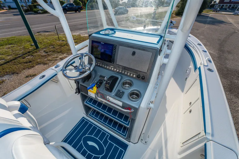 Slide: The Image of 2017 Crevalle 26 Open boat console with steering wheel and navigation system. - 24