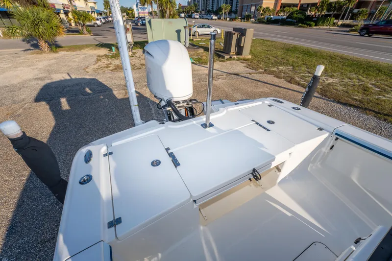 Slide: The Image of 2017 Crevalle 26 Open boat with outboard motor, parked near a road. - 34