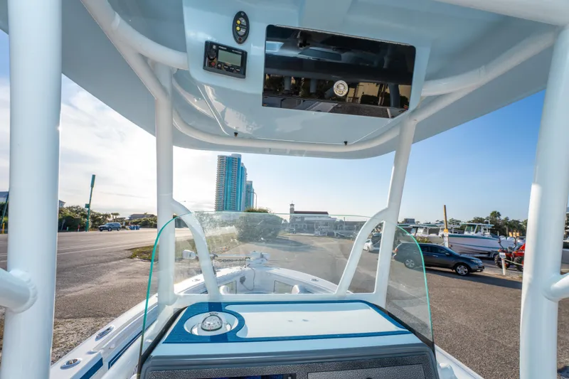 Slide: The Image of 2017 Crevalle 26 Open boat console with cityscape background. - 35