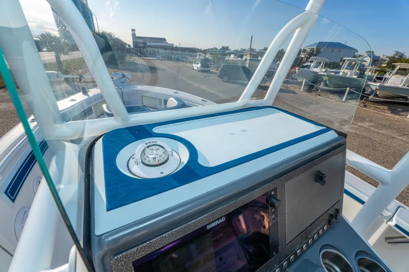 Slide: The Image of 2017 Crevalle 26 Open boat dashboard with compass and navigation system. - 36