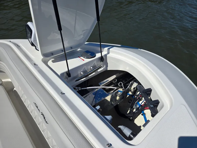 Slide: The Image of An open storage compartment on a Sea Ray SLX 360 Outboard boat, showing cables and equipment. - 26