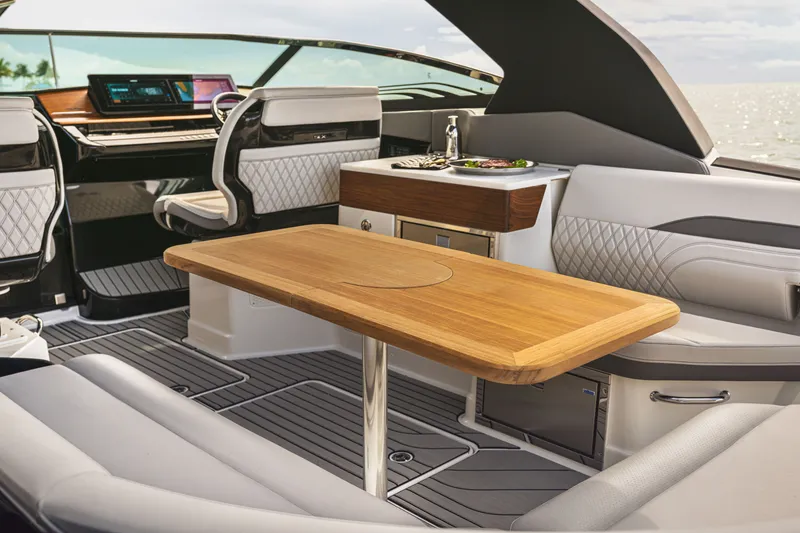 Slide: The Image of Interior of a Sea Ray SLX 360 Outboard with sleek seating and a wooden table. - 4