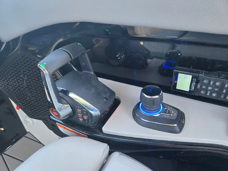 Slide: The Image of The image shows the helm of a Sea Ray SLX 360 Outboard with modern controls. - 15