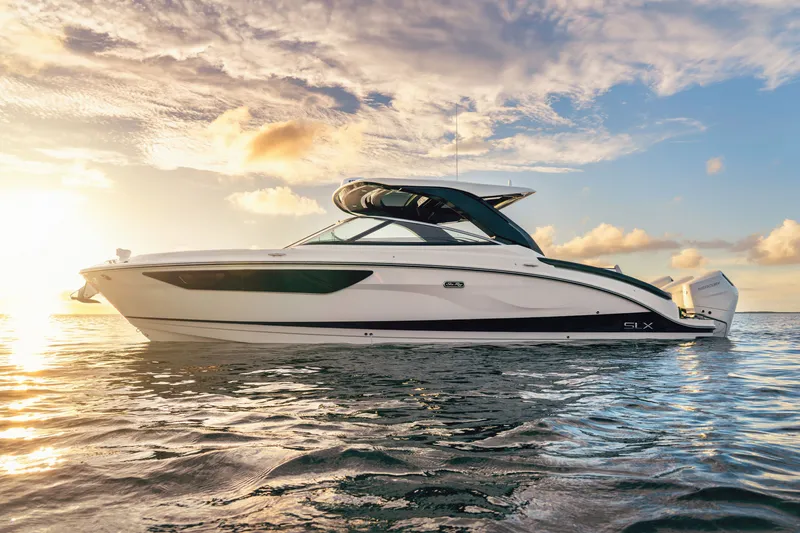 Slide: The Image of A sleek Sea Ray SLX 360 Outboard boat on calm water at sunset. - 8