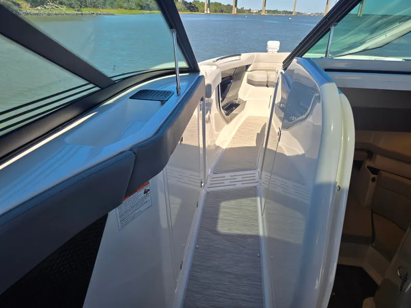 Slide: The Image of The image shows the walkway of a Sea Ray SLX 360 Outboard boat overlooking the water. - 21