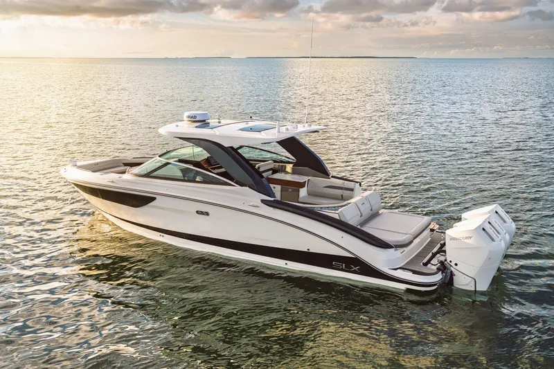 Slide: The Image of A sleek, modern boat on calm water with three outboard engines and a spacious deck. - 7