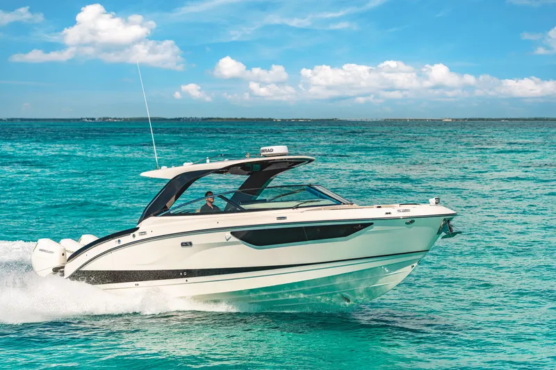 Slide: The Image of 2027 Sea Ray SLX 360 Outboard on turquoise water, featuring sleek design and modern hardtop. - 0