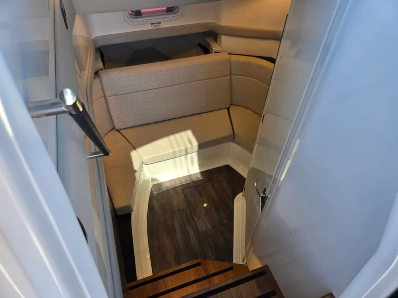 Slide: The Image of Interior view of a modern cabin with cushioned seating and wooden flooring. - 17