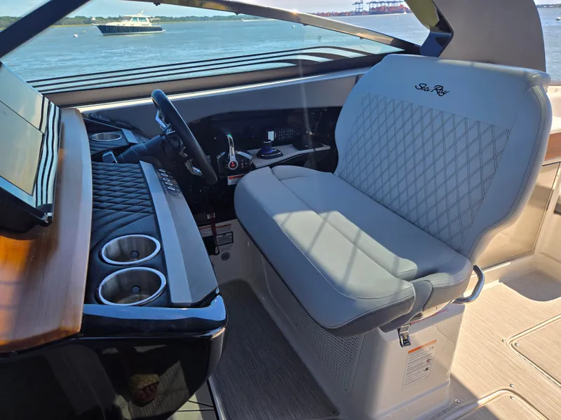 Slide: The Image of The 2027 Sea Ray SLX 360 Outboard cockpit features a sleek seat and modern dashboard. - 13