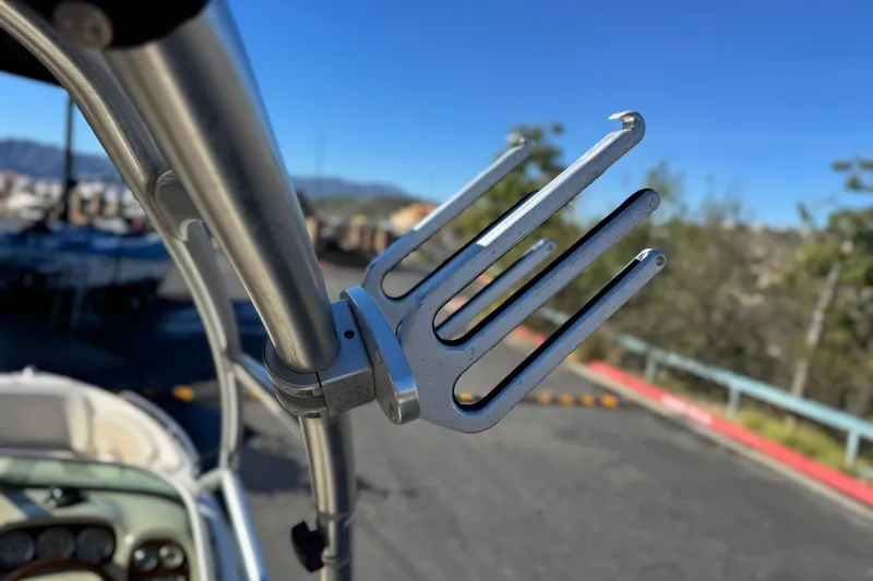 Slide: The Image of Wakeboard rack on a 2005 Chaparral 210 SSi boat, clear blue sky background. - 12