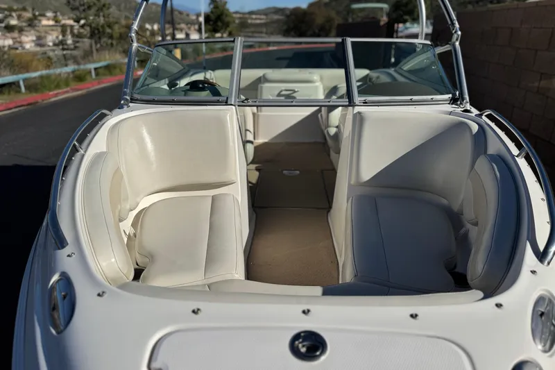 Slide: The Image of 2005 Chaparral 210 SSi boat interior with white seating and windshield. - 13