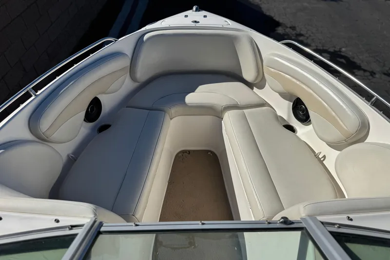 Slide: The Image of 2005 Chaparral 210 SSi boat interior with white cushioned seating and speakers. - 16