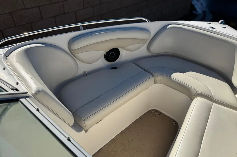 Slide: The Image of 2005 Chaparral 210 SSi boat interior with white cushioned seating and speaker. - 18