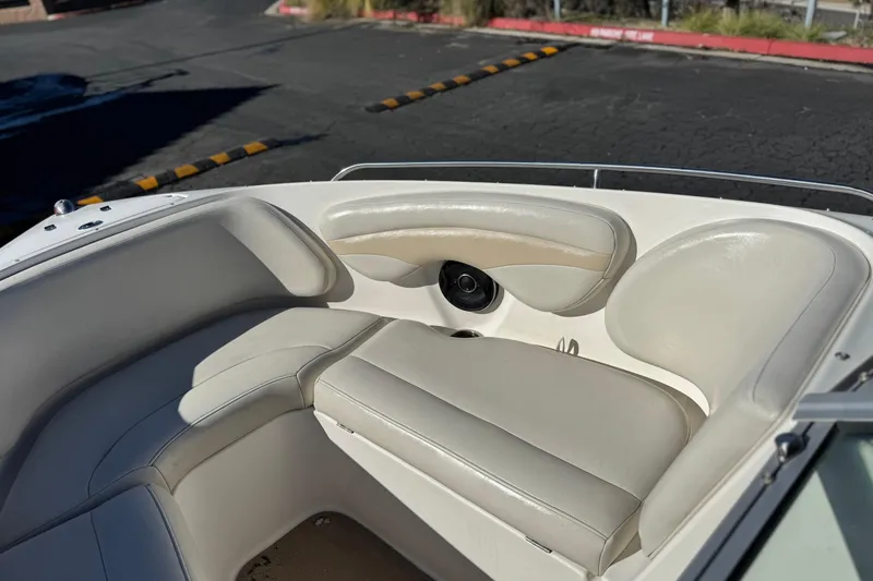 Slide: The Image of 2005 Chaparral 210 SSi boat interior with white cushioned seating. - 19