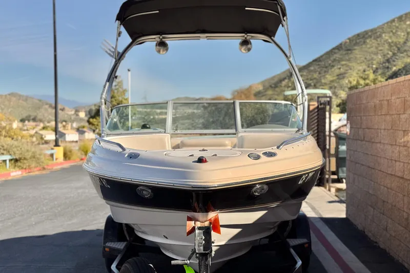 Slide: The Image of 2005 Chaparral 210 SSi boat on trailer, parked near scenic hills. - 2