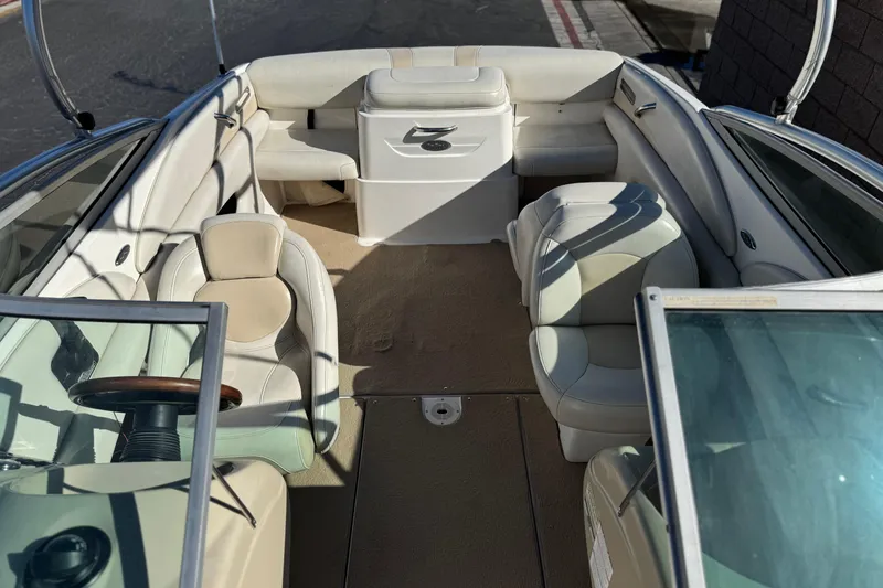 Slide: The Image of 2005 Chaparral 210 SSi boat interior with beige seating and steering wheel. - 20
