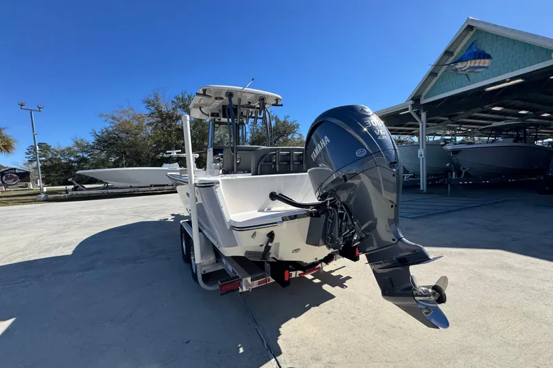 Slide: The Image of 2026 Sea Born LX24 Center Console boat with Yamaha V6 engine in a marina. - 15