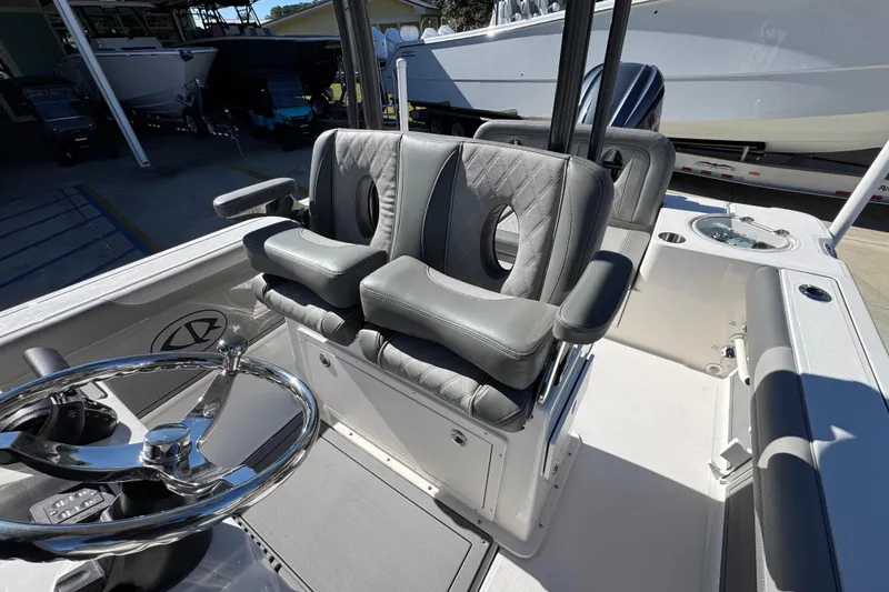 Slide: The Image of 2026 Sea Born LX24 Center Console boat with luxurious seating and steering wheel. - 26