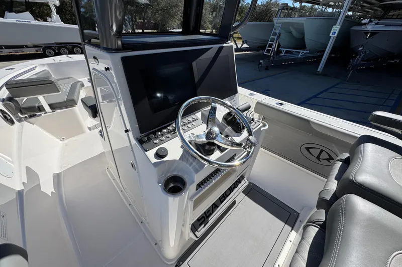 Slide: The Image of 2026 Sea Born LX24 Center Console boat interior with steering wheel and control panel. - 29