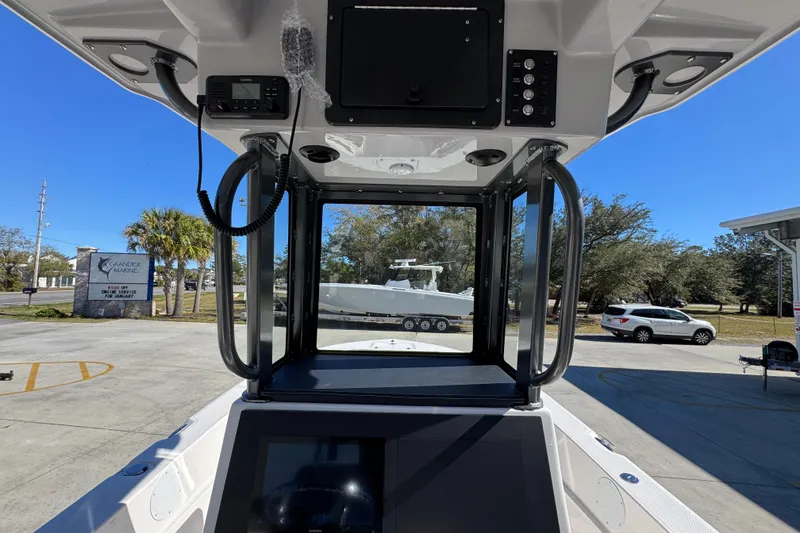 Slide: The Image of 2026 Sea Born LX24 Center Console boat interior with navigation equipment and outdoor view. - 31