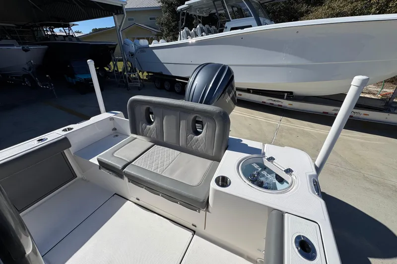 Slide: The Image of 2026 Sea Born LX24 Center Console boat interior with Yamaha engine, docked in a marina. - 34