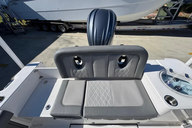 Slide: The Image of 2026 Sea Born LX24 Center Console boat interior with cushioned seating and storage. - 36